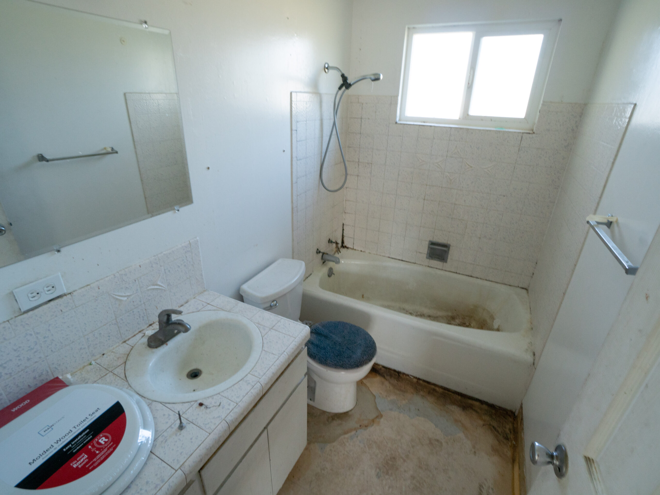 Dirty Bathroom needing to be cleaned and renovated.